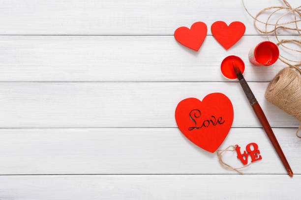 istock Valentine day diy handmade hearts making, top view on wood 639712422