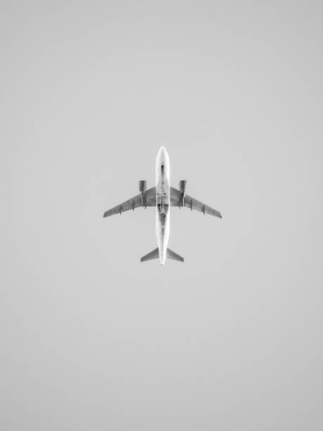 Underside of a commercial jet plane, isolated against grey background stock photo