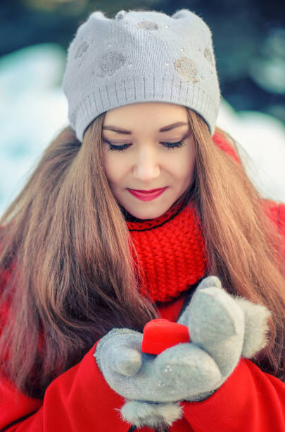 istock girl with the gift in a box in the shape 639714730