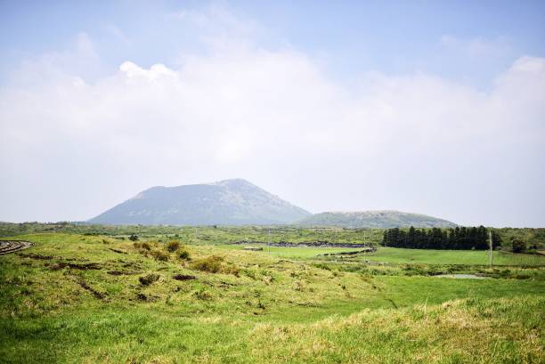 istock Green field and parasitic volcano 639715064
