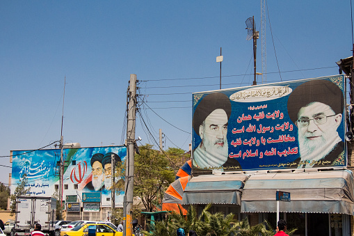 Kashan, Iran - August 13, 2016: billboards showing propaganda for the two Supreme leaders of the Islamic Republic of Iran, Sayyed Ali Hosseini Khamenei and Ruhollah Khomeini in the streets of the city of Kashan