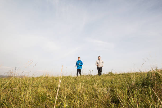 istock Two young hipster athletes running in sunny autumn nature 639715608