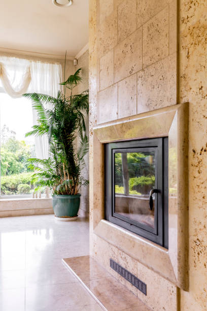 istock Travertine fireplace next to big window 639716516