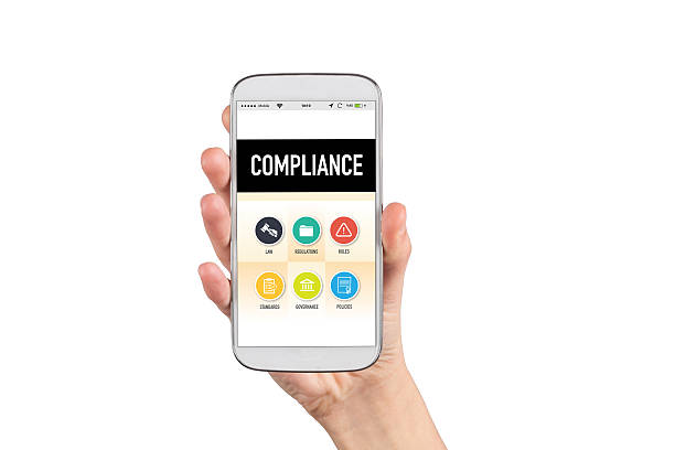 istock Smartphone in hand and showing Compliance concept on screen 639721338