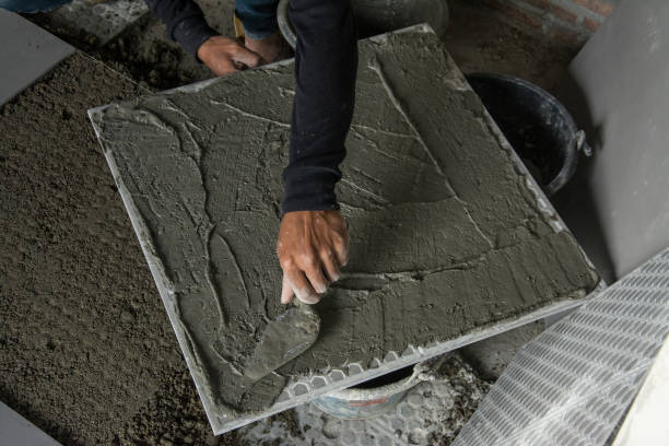 istock laying ceramic wood tiles on floor, installing tiles  in constru 639723994