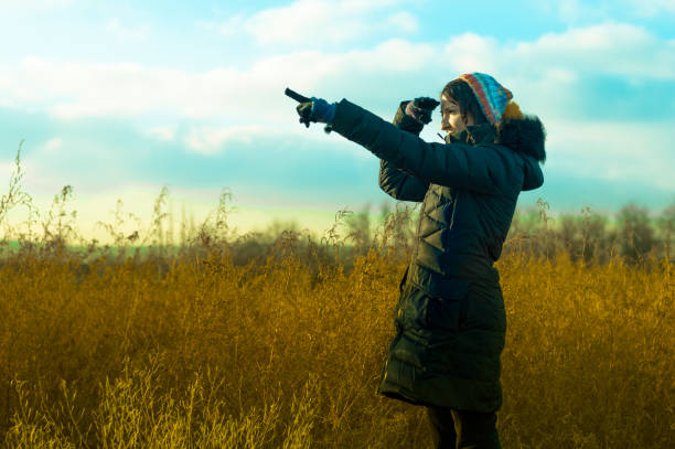 istock Woman in black pointing her finger towards blank space 639724168