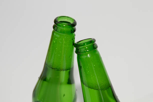 istock Two green beer bottles on white background 639724676