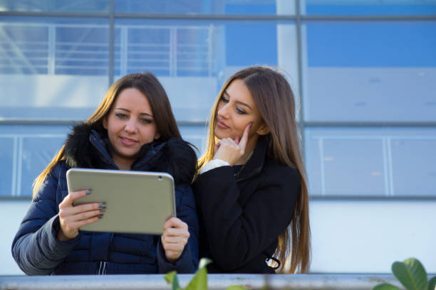 istock Two young women looking at tablet 639724804
