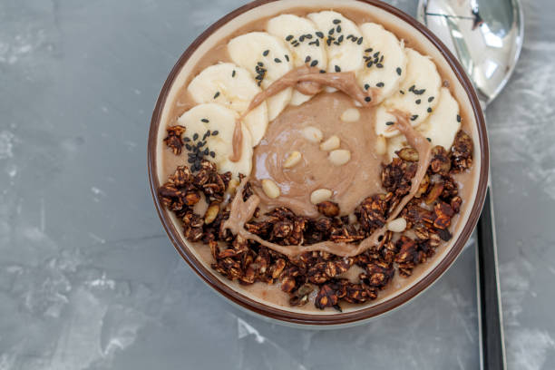 istock Breakfast smoothie bowl topped with chocolate muesli 639726980