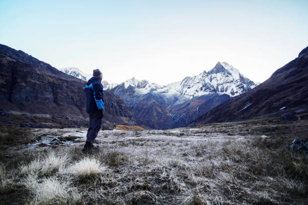 istock Hiker standing and looking at mountains view in the morning 639728548