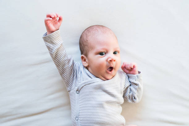 istock Cute newborn baby boy lying on bed, close up 639729220