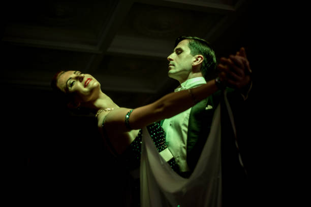 istock Latino dancers in ballroom  on black background 639733202