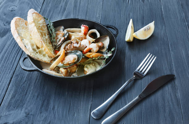 istock Seafood Stew in Saucepan on dark wood background 639733208