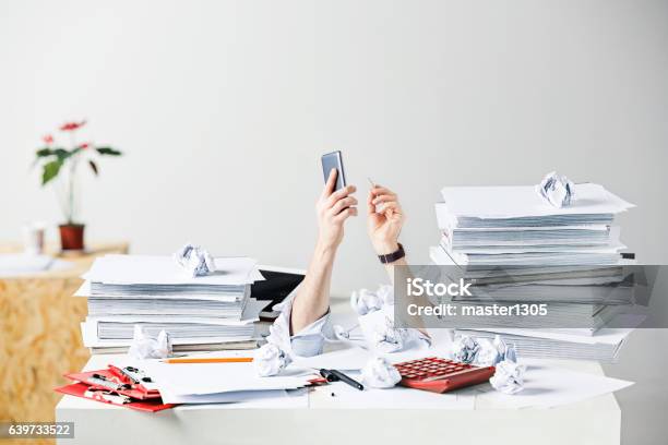 The Many Crumpled Papers On Desk Of Stressed Male Workplace Stock Photo - Download Image Now