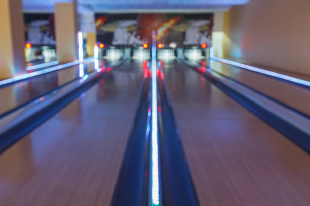 Bowling alley interior background Bowling background. Interior of bowling alley lane with glowing stripes, night light. Leisure activity club bowling alley wood stock pictures, royalty-free photos & images