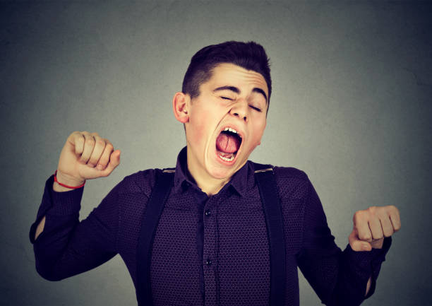 istock Sleepy man yawning stretching back. Sleep deprivation 639735806