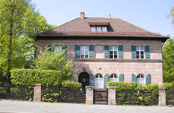 Nuremberg, Germany - April 22, 2011: suburb house made of Sandstone with fence. House stands in the south of nuremberg