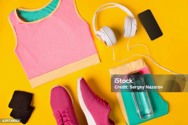 Fitness Accessories On A Yellow Background Sneakers Bottle Of Water Stock Photo - Download Image Now