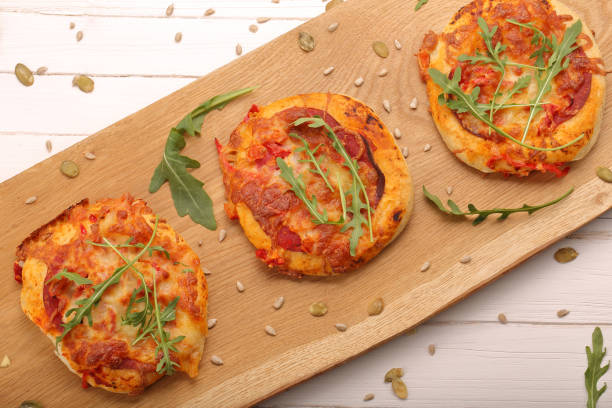 istock Small Pizza with mozzarella Cheese, ham and arugula 639739424