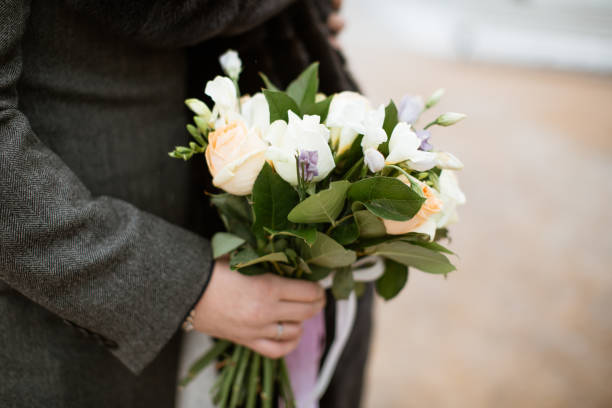 istock groom hold wedding bouquet 639740054