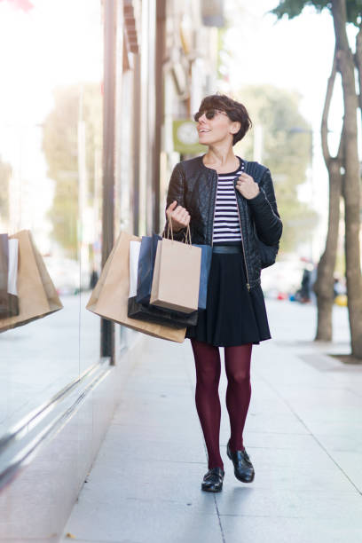 istock Woman looking at store window 639740328