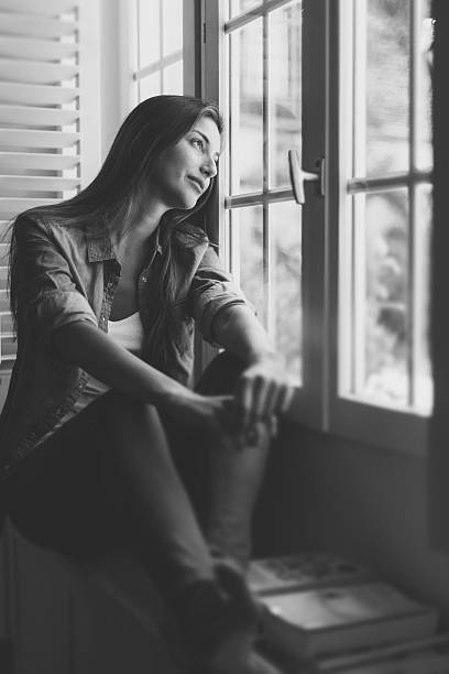 istock Dreamy woman on the window 639742916