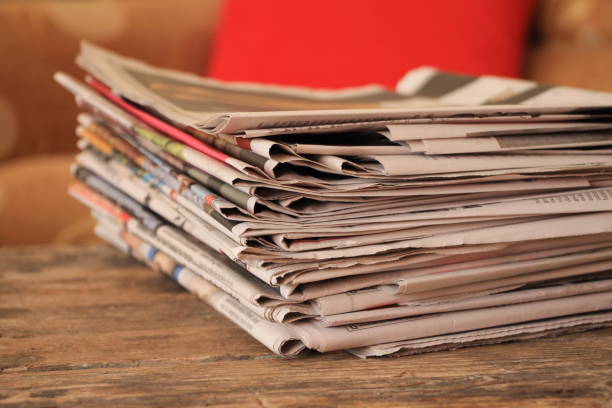 istock Newspapers on wooden table 639745894