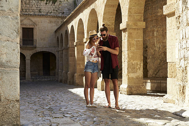 istock Couple sightseeing in Ibiza using a phone for guidance 639747792