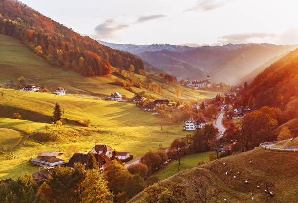Scenic panoramic view of a picturesque mountain valley in autumn Scenic panoramic view of a picturesque mountain valley in autumn at sunset. Colourful countryside landscape with mountain forests, traditional houses and old monastery. Germany, Black Forest. black forest photos stock pictures, royalty-free photos & images