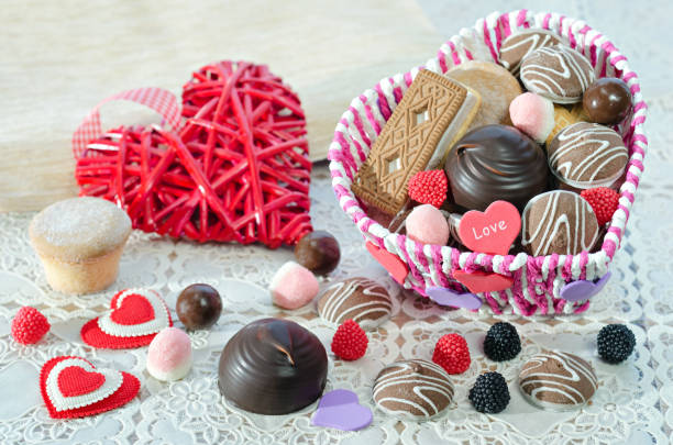 istock , Basket with sweets and biscuits on the table, decorative Valentine 639748522