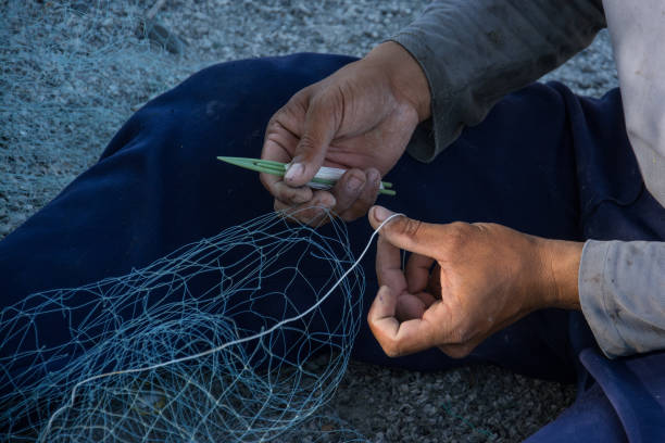 istock man making fishing net 639752944