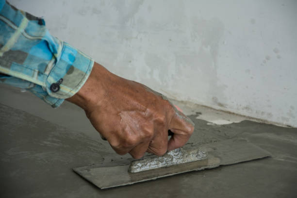 istock plasterer concrete worker at floor of house construction 639753242
