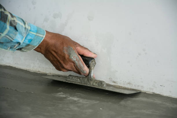istock plasterer concrete worker at floor of house construction 639753316