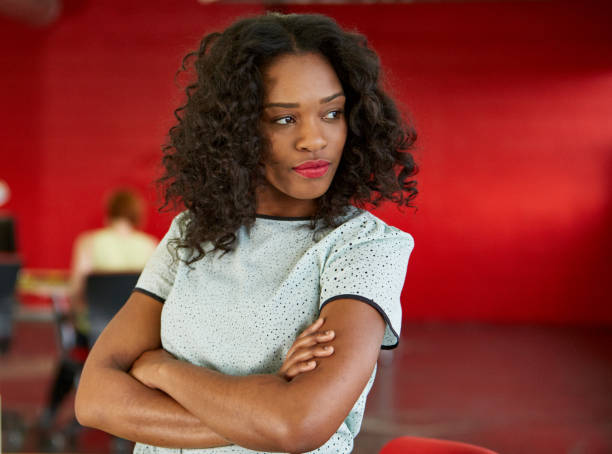 istock Confident female designer working in red creative office space 639753762