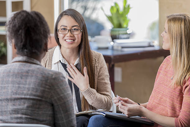 istock Young Asian woman expresses feelings during therapy session 639754346