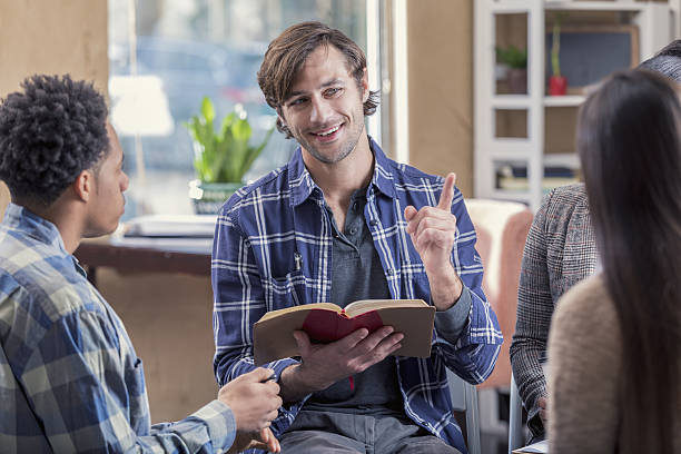 istock Confident man participates in a Bible study discussion group 639754374