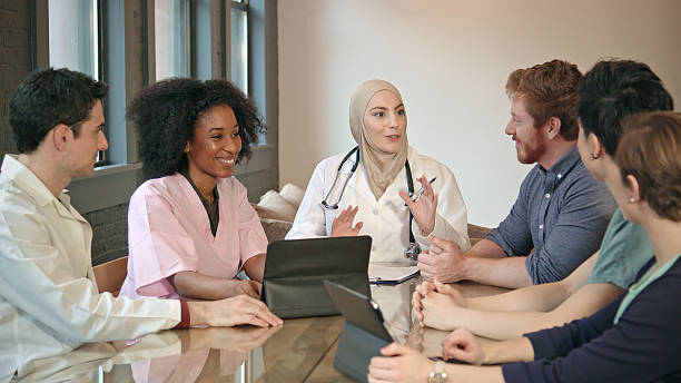 confident muslim doctor meets with healthcare professionals - teamwork medical research science women imagens e fotografias de stock