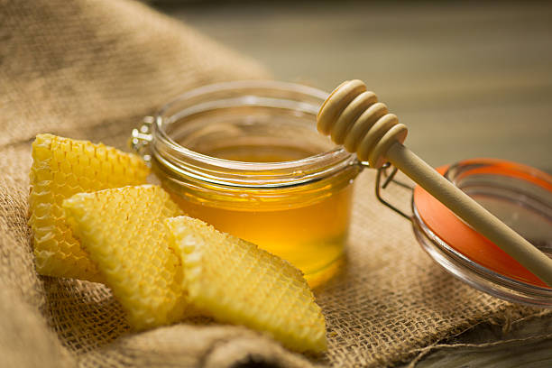 istock Glass with Honey on Wooden table 639758736