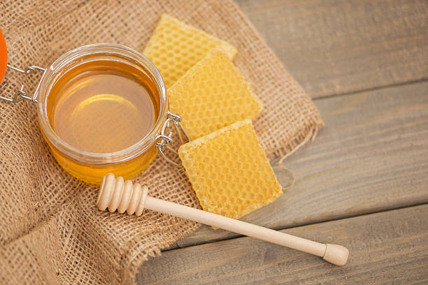 istock Glass with Honey on Wooden table 639758858