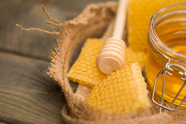 istock Glass with Honey on Wooden table 639759100