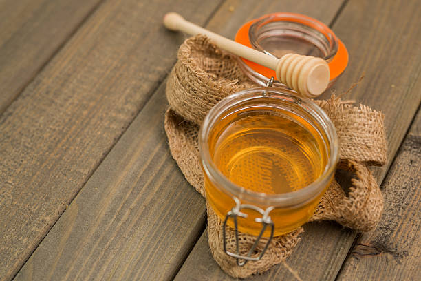 istock Glass with Honey on Wooden table 639759316