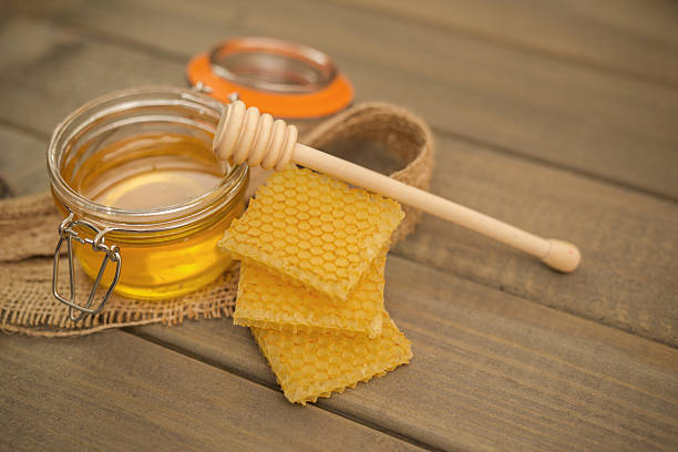 istock Glass with Honey on Wooden table 639759384
