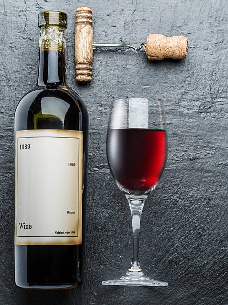 Wine bottle, wine glass and corkscrew.