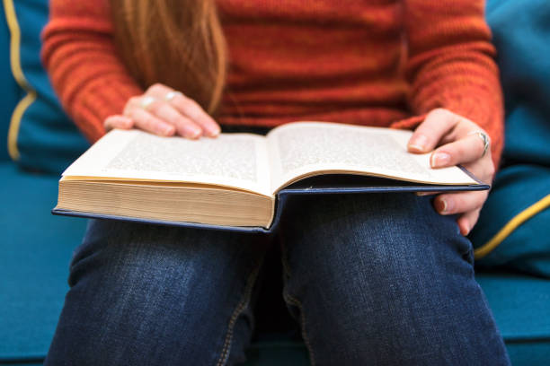 istock Woman hand on the opened book 639761460