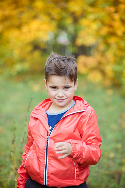 istock boy stands in the woods in the fall 639761544