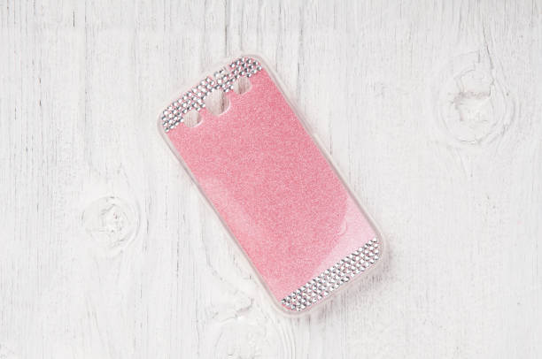 istock Pink plastic case for smart phone on white background 639762480