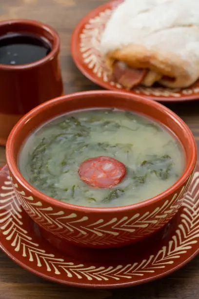 typical portuguese soup caldo verde with bread with chourico