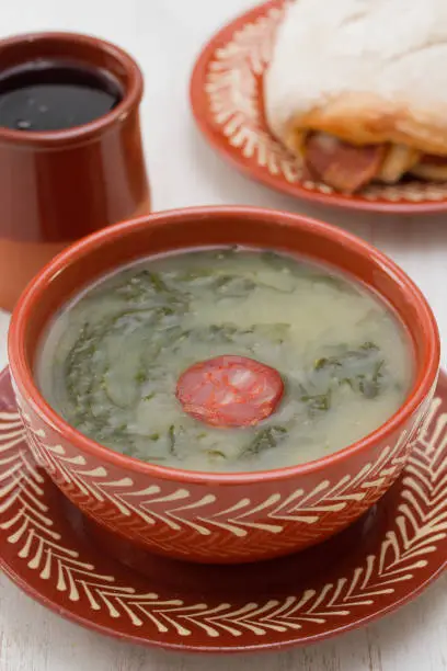 typical portuguese soup caldo verde with bread with smoked sausage