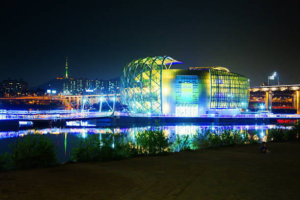 Seoul, South Korea - April 28, 2015: Seoul's Sebitseom some gavit illuminated complex at night. This new complex opened in 2015 and hosts numerous stores, conference halls, cafes and an elaborated LED looped light show at night. Banpo bridge is visible to the right as well as a the Seoul tower to the back left.