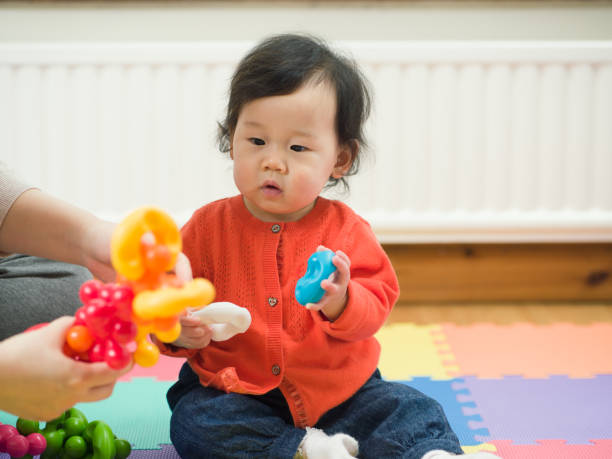 istock Asian baby playing toy at home 639766254
